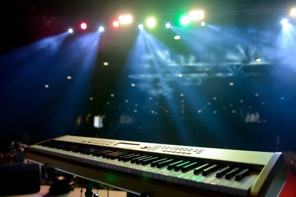 Keyboard on stage with colorful lights
