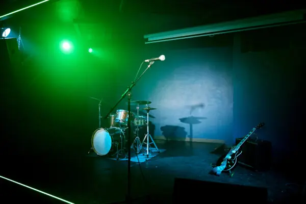 Empty stage with drum set and guitar